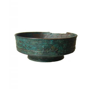 A small Roman bronze bowl: A small Roman bronze bowl, c. 1st - 4th Century AD, nicely turned with slightly raised foot. D: 2 1/3 in (5.9cm). Dark green patination with light encrustation. Ex estate of Harold Whitaker.