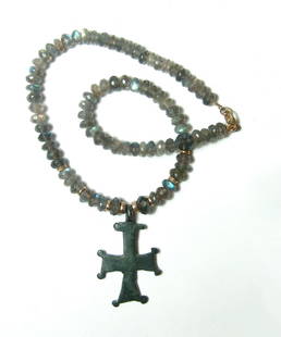 Byzantine bronze cross on beaded necklace: A Byzantine bronze cross on a labradorite and gold bead necklace. The cross is Byzantine, c. 8th - 11th Century AD, with attractive patination and set as a pendant on a necklace comprised of faceted
