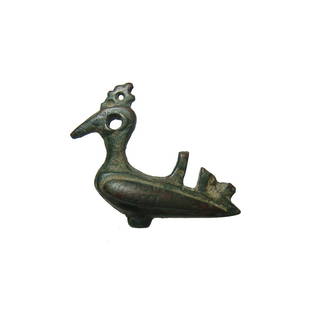 Detailed Seljuk bronze finial in the form of a peacock: A detailed Seljuk bronze finial in the form of a peacock, c. 12th Century AD, with openwork eye and tail. Likely originally a terminal for a pin or atop the handle of a bronze lamp. L: 1 3/4 in (4.4