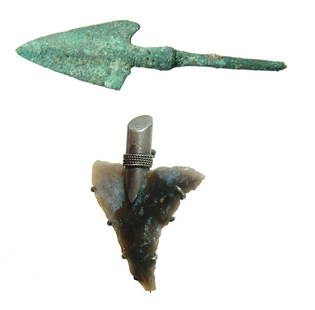 A pair of arrow points, one set in a silver brooch: A pair of arrow points, one set in a silver brooch. Lot includes a nice Near Eastern bronze arrowhead, c. 1000 - 600 BC, with nice green patina, (L: 3 1/8 in (7.9 cm), and a stone arrowhead fashioned