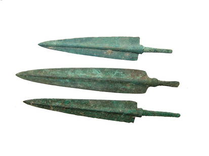 A lot of 3 choice Near Eastern bronze arrow points: A lot of 3 choice Near Eastern bronze arrow points, c. 1000 - 800 BC, each with pronounced midrib, tapered blade and squared shoulders. Each with slender stems for mounting into the shaft. Largest 6 1