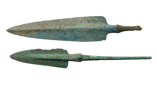 A pair of Near Eastern bronze weapons/arrow points: A pair of Near Eastern bronze weapons/arrow points, c. 1000 - 800 BC, each with pronounced midrib, lightly angled shoulders and preserved mounting tang. Largest 6 1/8 in (15.5 cm). Attractively