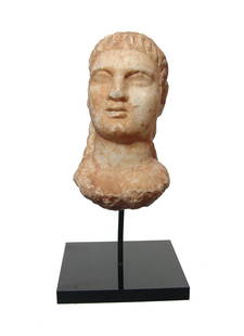 A well-detailed Roman marble head of a man: A well-detailed Roman marble head of a man, c. 1st - 2nd Century AD, with handsome features and closely cropped hair, the back of the pieces is unfinished suggesting it was part of a larger