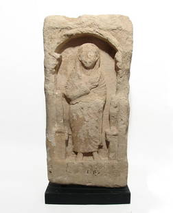 A splendid Roman limestone funerary stele: A splendid Roman limestone funerary stele, 2nd - 3rd Century AD, depicting a seated female within a decorated arcade, heavily robed, right hand at his chest, left by his side. 21 in x 10 3/4 in (43.2