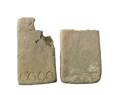 A pair of Near Eastern terracotta loom weights or tiles: A pair of Near Eastern terracotta loom weights or possibly a form of tiles or inlays, c. 2nd - 1st Millennium BC, each rectangular and originally with two horizontal holes through the sides, the ends