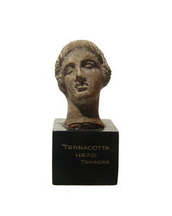 A lovely Greek terracotta head of a youth: A lovely Greek terracotta head of a youth, Tanagra, Boeotia, c. 4th - 3rd Century BC, with handsome features and hair in waves, the back of the head is roughly modeled. H: 1 7/8 in (4.8 cm). Light
