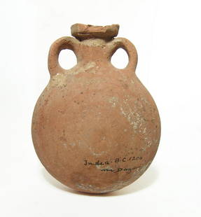 A large ceramic flask, Late Bronze Age: A large ceramic flask, Late Bronze Age, Eastern Mediterranean, c. 1500 - 1200 BC, with a pair of loop handles flanking the spout. The surfaces have encrustation and vestiges of concentric banding in