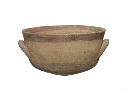 A Cypriot two handled bowl: A Cypriot two handled bowl, c. 750 - 600 BC, with banded decoration in dark brown slip. 4 x 2 3.8 in (10.2 x 6 cm). Well-preserved with light deposits. Ex Desmond Morris collection, Nottingham, UK.