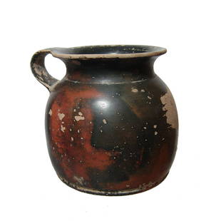 A Greek black glazed oinochoe: A Greek black glazed oinochoe, c. 5th - 4th Century BC, a drinking cup, the squat body with wide, flat bottom, flared mouth and wide looped handle. H: 3 3/4 in (9.5 cm). Ex German private collection