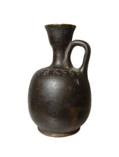 A cute little Campanian Greek squat lekythos: A cute little Campanian Greek squat lekythos, Magnia Graecia, c. 4th Century BC, the shoulders with impressed palmette motif. H: 4 1/8 in (10.4 cm). Light deposits, old wax collection seal on bottom.