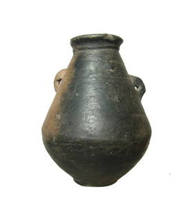 A Villanovan/Etruscan impasto jar: A Villanovan/Etruscan impasto jar, c. 8th - 7th Century BC, piriform in shape with shallow ring foot, the neck narrows and is surmounted by a flared mouth, two vertically orientated lug handles on