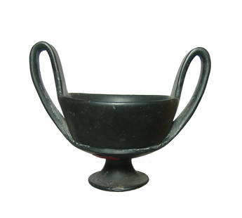 A well-preserved Etruscan bucchero kantharos: A well-preserved Etruscan bucchero kantharos, c. 625 - 550 BC, on pedestal foot, the deep bowl with horizontal ridge at base and two loop handles. 5 1/2 x 6 3/4 in (14 x 17.1 cm). Well-preserved