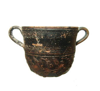 A nice Roman orange-ware cup with molded decoration: A nice Roman orange-ware cup with molded decoration, North Africa, c. 4th - 5th Century AD, with a molded grape vine pattern around the bottom of the body, multiple groups of horizontal banding with