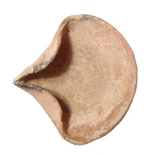 A nice Iron Age pinched ceramic lamp: A nice Iron Age pinched ceramic lamp, c. 1200 - 586 BC, a popular 'cocked hat' type with remnants of carbon on the nozzle and a raised pad base. 5 1/8 x 5 3/8 in (13 x 13.7 cm). Light deposits. Ex