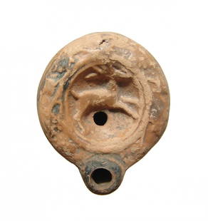 Interesting little Roman discus lamp depicting a stag: An interesting little Roman discus lamp depicting a stag, 1st Century AD, a symbol of the goddess Diana, the stag prances right within a deeply concave discus, fill-hole below, vine motif around the