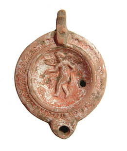 A nice Roman ceramic lamp depicting a winged Erote: A nice Roman ceramic lamp depicting a winged Erote, late 2nd - early 3rd Century AD, who stands winged before what appears to be a ladder leaning against a column, depicted nude with chlamys and
