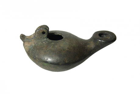 A nice Roman bronze oil lamp: A nice Roman bronze oil lamp, 3rd - 4th Century AD, with smooth, rounded body and long nozzle with circular wick hole; the bottom flattened. At back is the base for the handle and the hinged