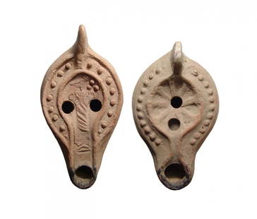 A pair of Roman ceramic lamps: A pair of Roman ceramic lamps. The first is a North African type, c. 4th - 5th Century AD, the flat top with central relief of a bird standing atop a spiral column, berries before, the shoulder with