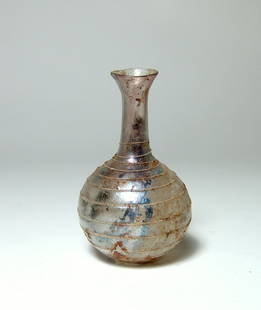 A nice Roman glass spiral bottle: A nice Roman glass spiral bottle, c. 1st Century AD, in near colorless glass, the body rounded with narrow neck and flared mouth, the entire vessel adorned with a spiral trail wound in opaque white