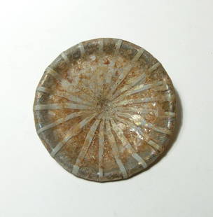 A Roman lid for a glass pyxis, 1st Century AD: A Roman lid for a glass pyxis, 1st Century AD, in colorless glass with vertical white banding, the shape of round conical form with low central point, the edges rolled upward with scalloped edging. A