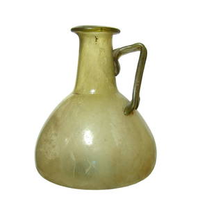 A wonderful olive-green Roman glass bottle: A wonderful olive-green Roman glass bottle, 2nd - 3rd Century AD, the body of wide piriform shape with lightly indented bottom. The tubular neck is surmounted by a wide rim and the single strap