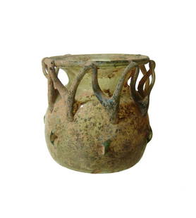 A Roman yellow glass cage vessel: A Roman yellow glass cage vessel, 4th - 5th Century AD, the rounded body with deeply indented base, small pinched 'loops' around the sides of the body and a zig-zag trail around the neck attaching to