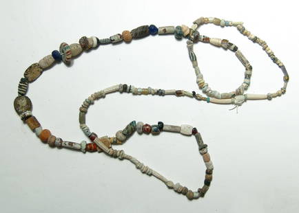 A strand of primarily Hellenistic and Roman glass beads: A strand of primarily Hellenistic and Roman glass beads, c. 2nd Century BC - 2nd Century AD, of various types including mosaic, translucent and others. Also included are various stone and glass beads