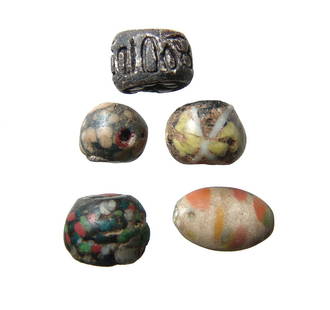 A beautiful group of ancient glass beads: A beautiful group of ancient glass beads. Two are late Roman speckled types, c. 1st - 4th Century AD, with opaque black core and multicolored spots, (15 x 12 mm & 13 x 11 mm). Another is ovoid in