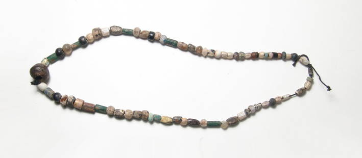 Nice necklace comprised mostly of Roman glass beads: A nice necklace comprised mostly of Roman glass beads, c. 1st - 4th Century AD, in various colors including translucent blue and green. Also strung are stone and faience beads from other periods. L: