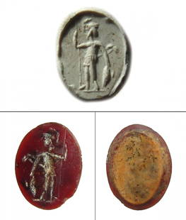 A Roman carnelian ring stone depicting Mars: A Roman carnelian ring stone depicting Mars, 1st - 2nd Century AD, in military attire and wearing a crested helmet, holding a spear and resting on a shield. 18 x 13.5 mm. Ex collection of Horatio and