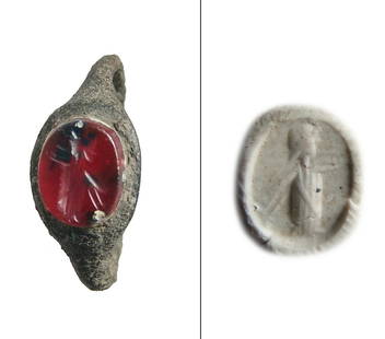 A Roman bronze ring with carnelian ring stone: A Roman bronze ring with carnelian ring stone, c. 2nd - 3rd Century AD, the ring slender with oval bezel, the deep orange stone with a nicely incised deity standing in profile. Ring stone 9 x 6 mm,