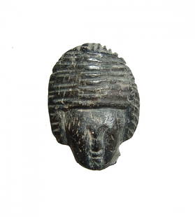 Near Eastern, possibly Cypriot, steatite woman's head: A Near Eastern, possibly Cypriot, black steatite head of a woman, 1st Millennium BC, nicely carved with detailed facial features and a close-fitting wig in Egyptian style, H: 1 1/10 in (2.8cm). Ex