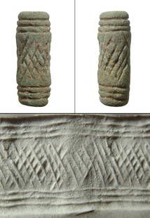 A Near Eastern faience cylinder seal or bead: A Near Eastern faience cylinder seal or bead, 2nd Millennium BC, decorated with cross-hatching pattern. H: 7/8 in (2.2cm). Ex Wiltshire, UK private collection.