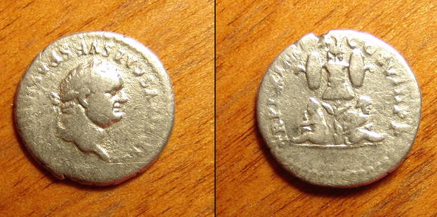 A Roman silver coin of emperor Titus: A Roman silver coin of emperor Titus. Imperial Rome, Titus, AD 79 - 81. AR Denarius. Rome. (18.35mm. 3.73g). TITVS CAES VESPASIAN AVG PM, his laureate head rt. / TR P IX IMP XV COS VIII PP, two bound