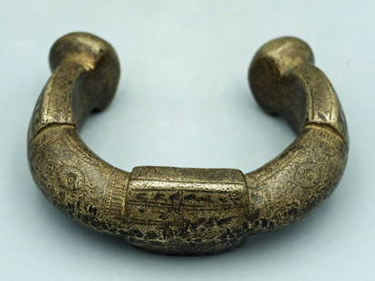 A choice Tuareg manilla, Mauretania: A choice Tuareg manilla, c. late 1800's - early 1900's. This heavy solid bronze currency bracelet is 3 1/2 in (8.9 cm) in diameter and is lavishly decorated with a variety of geometric and linear