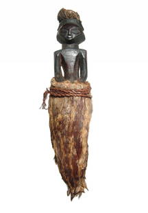 A nice African carved wood votive of a woman in skirt: A nice African carved wood votive of a woman in skirt, early - mid 20th Century. She is nicely carved and depicted kneeling on integral base, her features nicely carved and wearing an animal skin skir