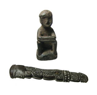 A pair of objects from Africa and New Guinea: A pair of objects from Africa and New Guinea. Lot includes a lovely carved wood ornamental piece, New Guinea, perhaps a handle, in the form of a seated figure with incised swirled filled with white,