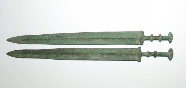 A wonderful pair of replica Chinese bronze swords: A wonderful pair of replica Chinese bronze swords. Each a faithful representation of a type used in the Warring States Period, c. 475 - 221 BC, and attractively patinated. Both 21 1/2 in (54.4 cm).