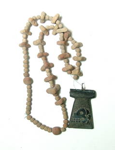 Costa Rican-style replica axe stone blade on necklace: A nice beaded necklace with Costa Rican-style replica axe stone blade, one side of the axe with a carved skull in profile, the opposite side polished and top drilled horizontally for suspension. The