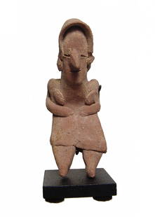 A nice Colima figure of an old woman: A nice Colima figure of an old woman, West Mexico, 100 BC - AD 250, bent over, her back in pain. She is neatly modeled wearing a hooded bonnet and skirt, her hands on the side of her belly. H: 3 1/4