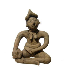 A Colima seated ceramic figure of a man: A Colima seated ceramic figure of a man, West Mexico, c. 100 BC - AD 200, depicted seated with legs crossed, with rolled headdress and holding a large shell in his right hand. The features are