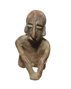 A Jalisco ceramic figure of a seated male: A Jalisco ceramic figure of a seated male, West Mexico, c. 200 BC - AD 200, resting hands on knees. He wears a wrapped headdress and his eyes are wide with angular nose. H: 5 3/4 in (4.6 cm).