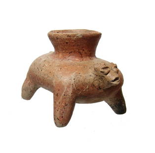 A nice Jalisco standing canine effigy vessel: A nice Jalisco standing canine effigy vessel, West Mexico, c. 100 BC - AD 250, the body of flat ovoid shape with tapered legs and a spout on back. The head is small and nicely modeled with coffee