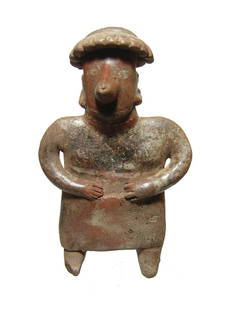 A nice Nayarit standing woman wearing a skirt: A nice Nayarit standing woman wearing a skirt, West Mexico, 100 BC - AD 250, wearing a low headdress fringed with feathers, earrings, nose ring and choker. H: 7 in (17.8 cm). Well preserved with