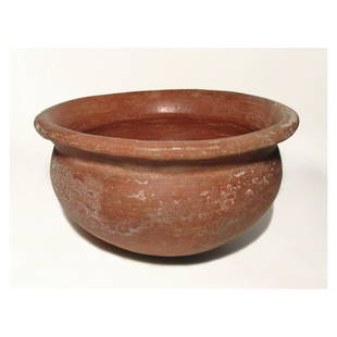 A huge Colima red slipped cooking vessel: A huge Colima red slipped cooking vessel, West Mexico, c. 100 BC - AD 200, heavy-bodied, with deep rounded bowl and flared rim. H: 8 in (20.3 cm); Dia: 14 in (35.5 cm). Red-slipped surfaces well