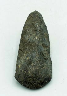 A choice Maya hardstone celt: A choice Maya celt, Guatemala, c. AD 250 - 600, made from speckled hardstone. It retains a sharp, highly polished bit, pointed butt end, and shows good mineral deposits. L: 4 3/4 in (12.1 cm). An