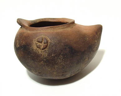 A Nicoya monochrome shoe pot: A Nicoya monochrome shoe pot, Costa Rica, AD 1200 - 1550, with little applique hallucinogenic buttons/adornos on either side and a small zoomorphic applique at the back. Attractive black/orange