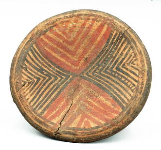 A lovely Nicoya tripod plate with zoomorphic legs: A lovely Nicoya tripod plate, Costa Rica, c. AD 1000 - 1500, decorated with an intricate butterfly-form linear design pattern executed in red and black over the tan slip. The hollow legs are in the fo