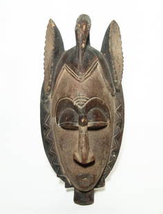 A nice West African mask, Guro culture: A nice West African mask, Guro culture, Ivory Coast. The well-carved mask is in the form of a man with pursed lips, large nose and closed eyes. The hair is cut short with a headdress consisting of a