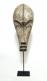 A beautiful African wood mask, Fang culture: A beautiful African wood mask, Fang culture, Republic of Congo, in the form of a man with elongated face, inverted crescent-shaped eyes, slender nose and down-turned mouth. The surfaces are coated whi